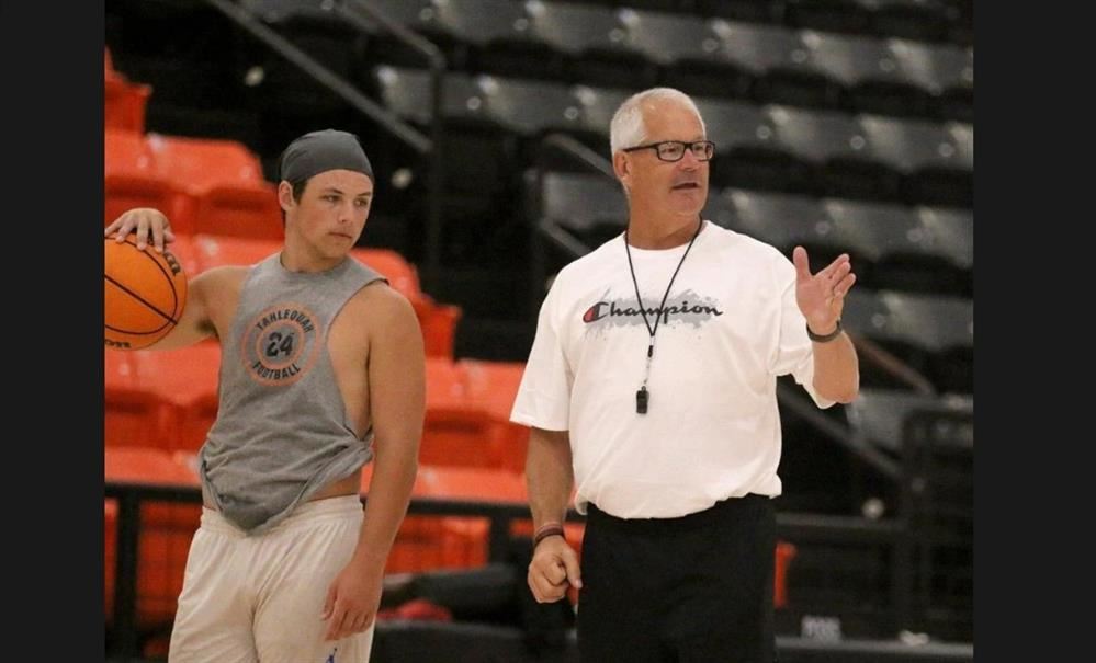  Coach Klingsick and basketball player on court